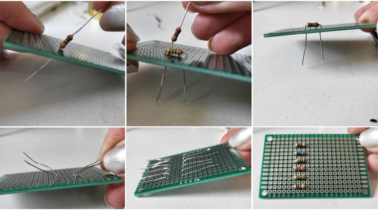 Figure 10.14 – Pushing resistors into a protoboard and opening the legs so it stays in place
