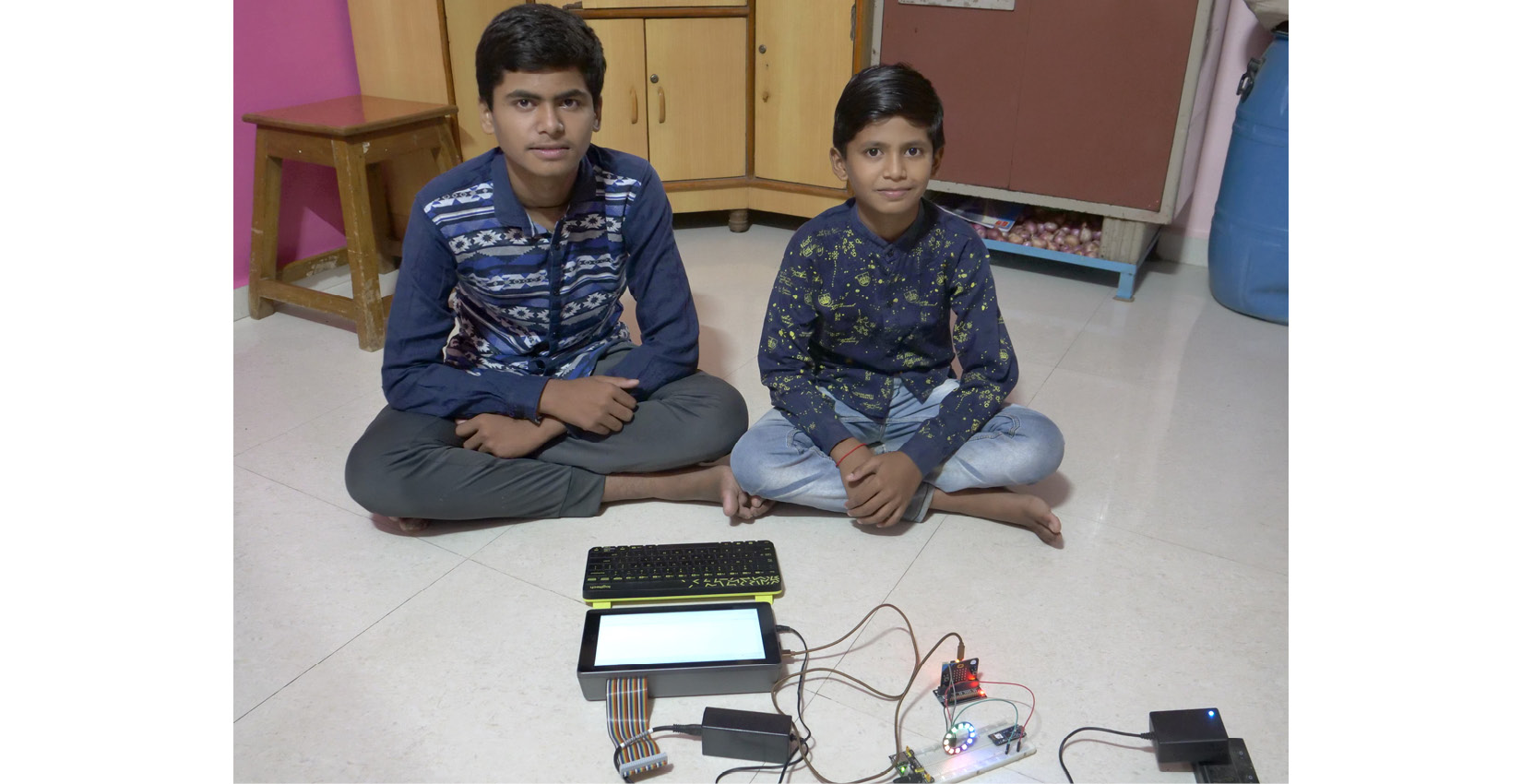 Figure 4.3 – Schoolkids working on a NeoPixel with a Micro:bit
